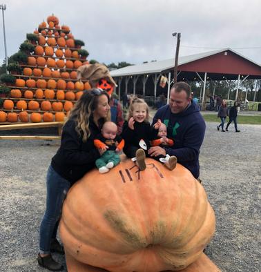 family with a Big Orange giant pumpkin